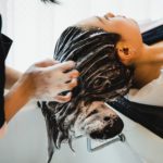 Asian woman has her hair washed at a hair salon
