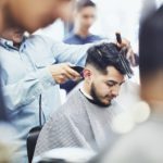 Man having hair cut in barber shop